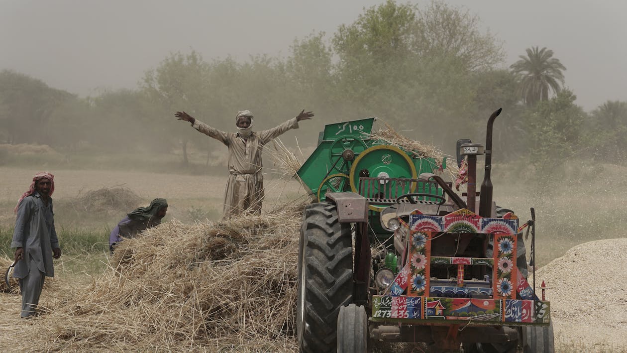 Farmers using rented farm machinery in rural Pakistan